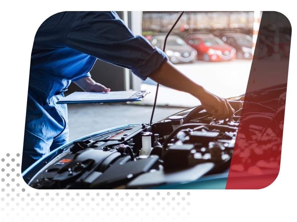 mechanic stands with a clipboard in front of engine