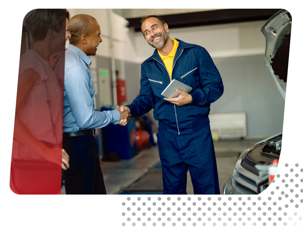 Car technician shaking hands with customers.
