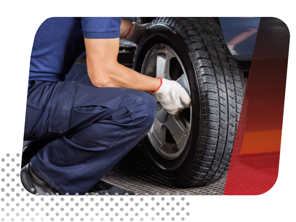 car technician replacing a tire.