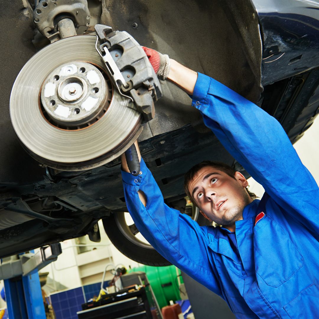 mechanic working on brakes