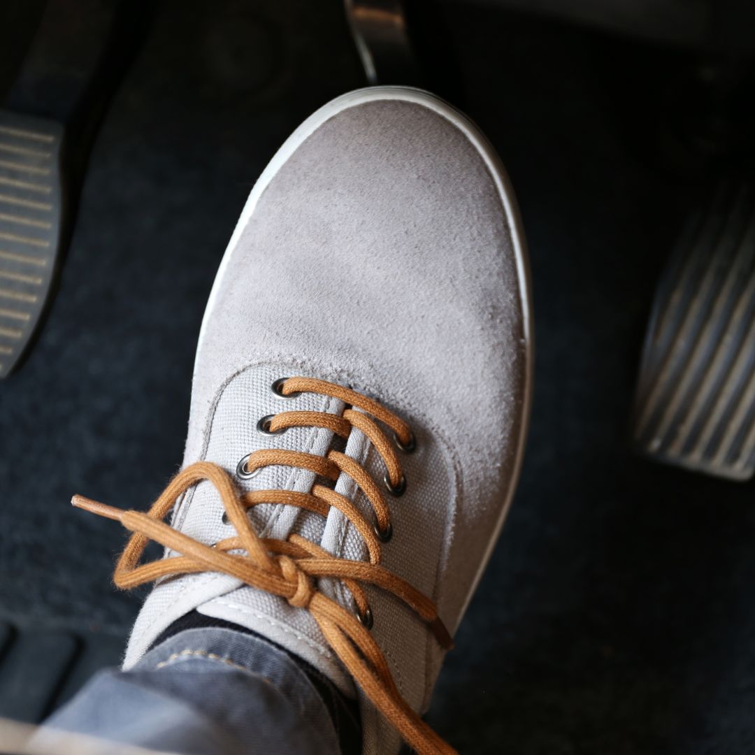 driver pressing brake pedal