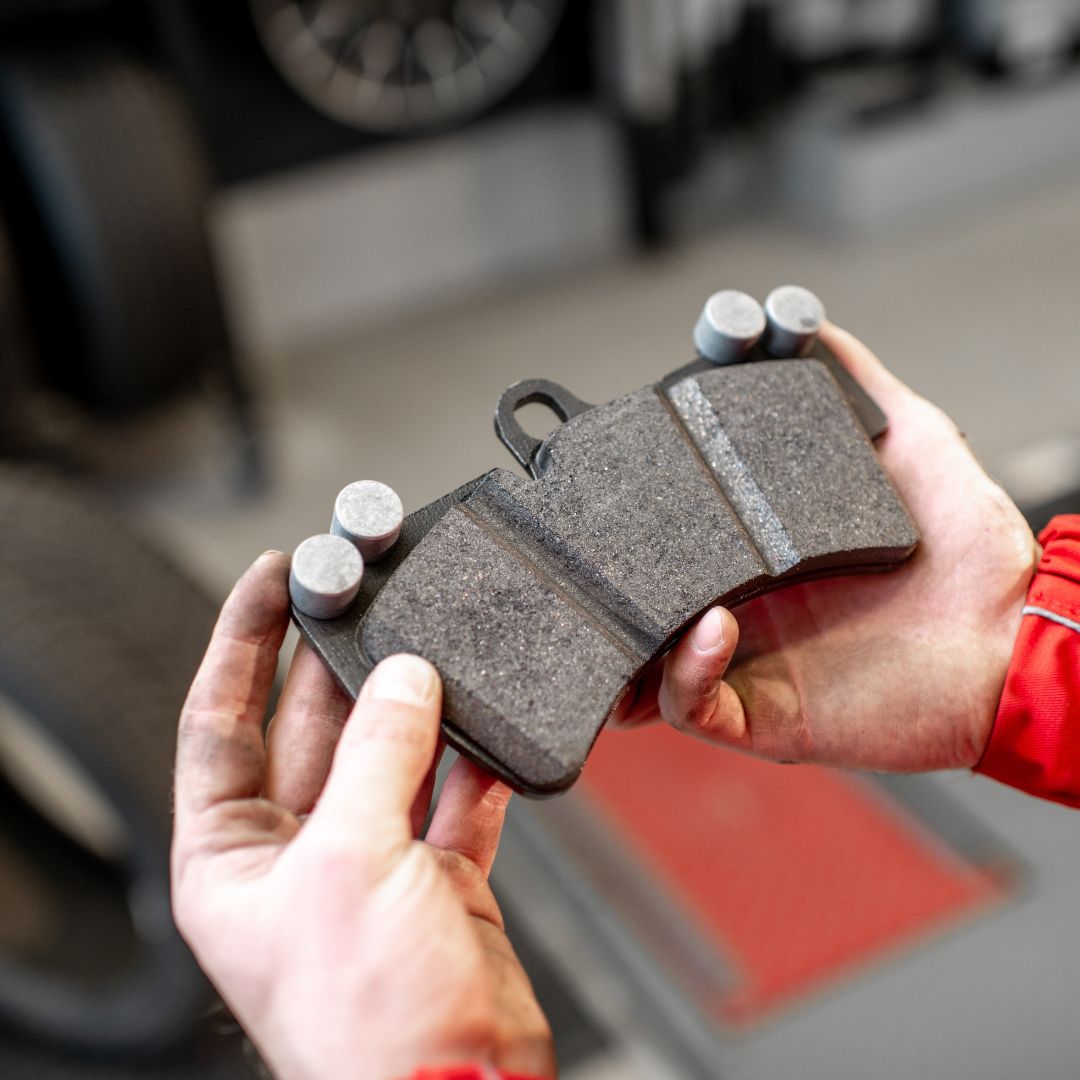 mechanic inspecting brake pads
