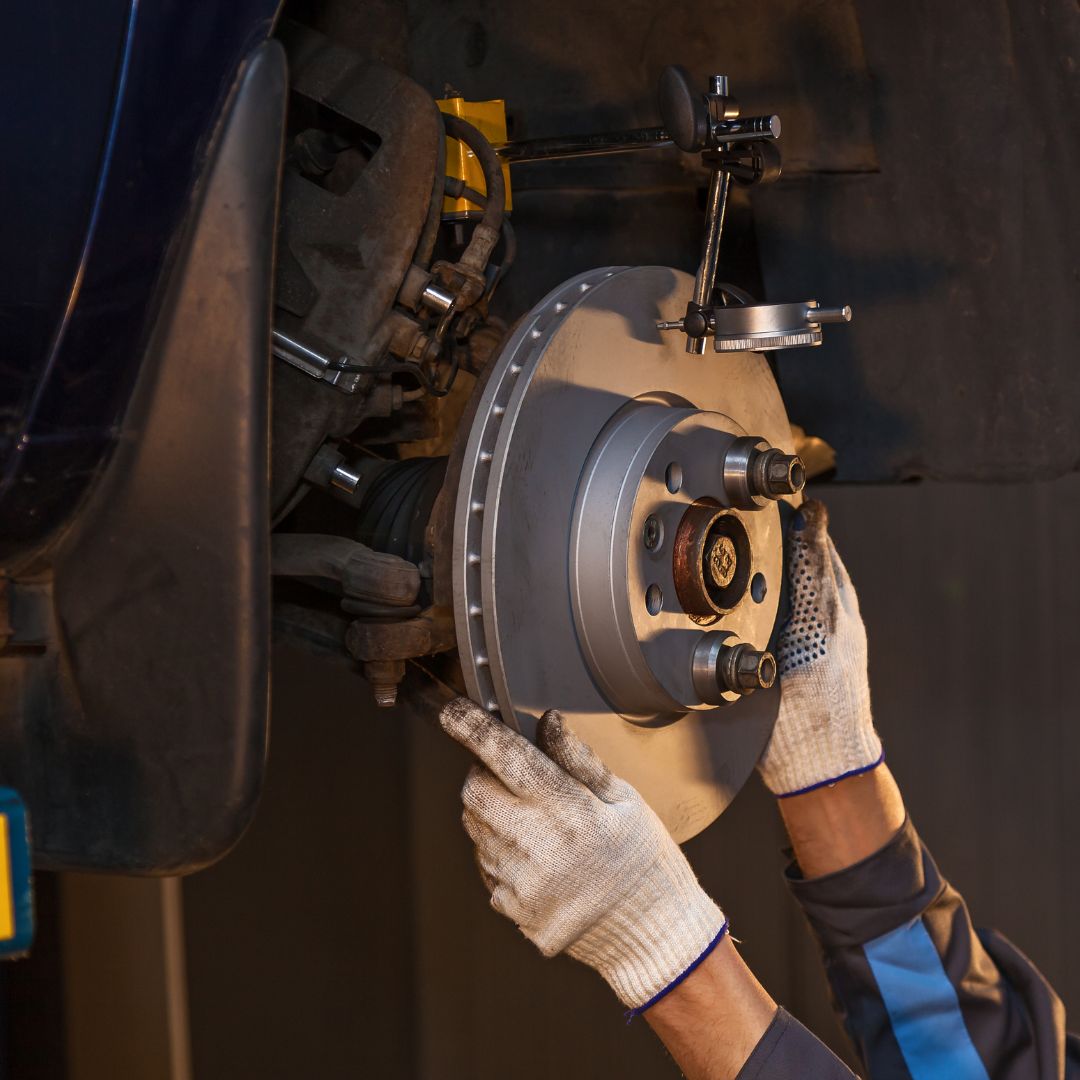 mechanic working on brakes
