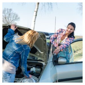Two women with one looking at the engine of a car and the other standing inside the door