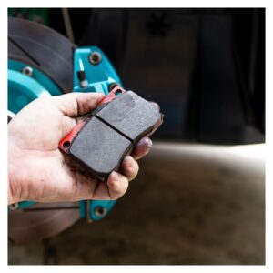 Holding a break pad to check condition
