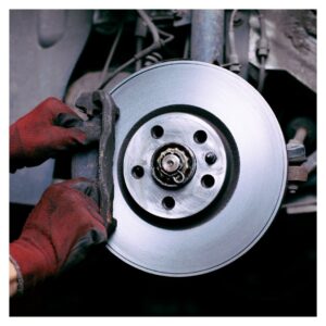 Technician installing new brake pad